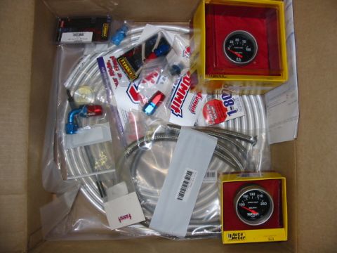 1985 Ford LTD Crown Victoria - Contents of a box filled with Summit Racing automotive parts and gauges.