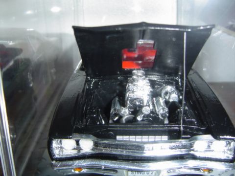 1979 Ford Bronco - This is a model car with its hood open, revealing a detailed engine and a red Chevrolet emblem.