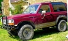 1989 Ford Bronco II - This Ford Bronco II is parked on a grassy lawn with a stone structure in the background.