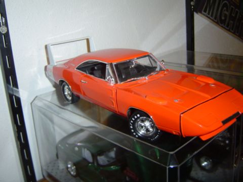 1979 Ford Bronco - Model car of a 1969 Dodge Charger Daytona displayed on a shelf.