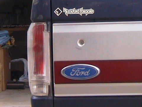 1991 Ford Bronco - Rear view of a 1991 Ford Bronco, the Ford oval emblem and a Rockford Fosgate sticker on the tailgate.