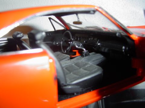 1979 Ford Bronco - Close-up view of the interior of an orange model car, showing seats and dashboard details.