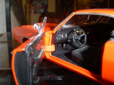 1979 Ford Bronco - The interior of a model car is shown with the driver's side door open.