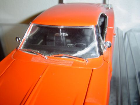 1979 Ford Bronco - Close-up view of an orange car model's front end, highlighting the windshield and hood.