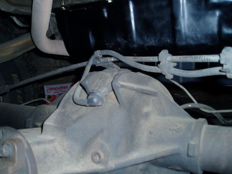 1990 Ford Bronco - Rear differential housing with visible wiring and a ramen noodle box in the background.