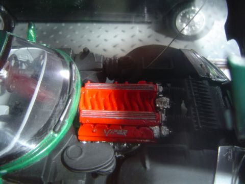 1979 Ford Bronco - Close-up of a model car's engine bay, red Viper engine covers.
