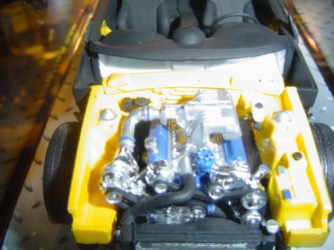 1979 Ford Bronco - Detailed model of a car's engine bay, chrome and blue components.