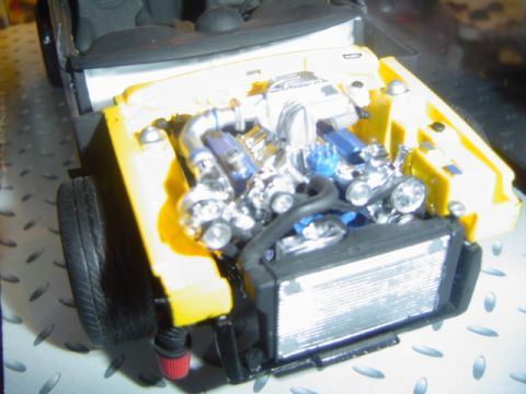 1979 Ford Bronco - A detailed model of a vehicle's engine bay is shown, a supercharger and intricate components.