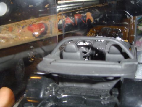 1979 Ford Bronco - Close-up view of a toy car's interior, showing the dashboard and seats.
