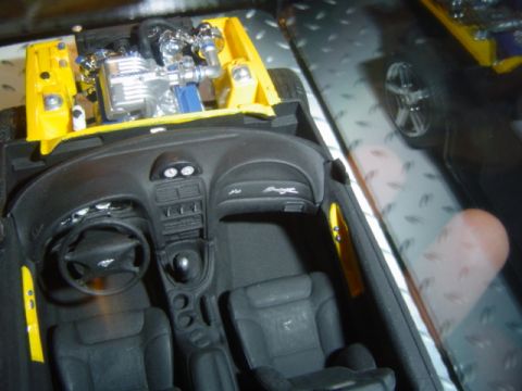 1979 Ford Bronco - Model car interior and engine bay detail, yellow paint, black seats and dashboard.