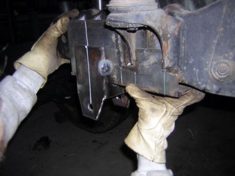 1995 Ford Bronco - Custom bracket being fitted to an axle housing for modification.