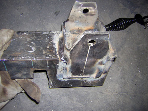 Welded steel bracket with mounting plates and holes on concrete floor