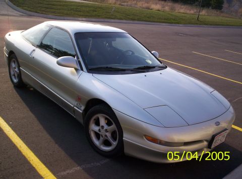 1994 Ford Probe - A silver 1994 Ford Probe is parked in a lot with yellow lines on the pavement.