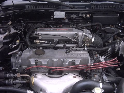 1989 Mazda MX-6 - Close-up view of a Mazda engine, highlighting the turbo intake and 16-valve cover.