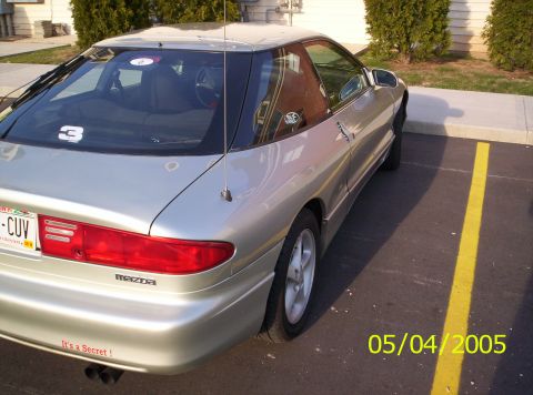 1994 Ford Probe - This silver 1994 Ford Probe is seen from the rear in a parking lot, with a visible Mazda badge.