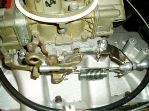 1966 Ford Fairlane - Carburetor linkage detail showing throttle cable and return spring mechanism.
