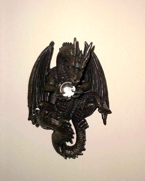 1976 Ford F-150 - Dragon figurine with a clear orb is mounted on a wall.
