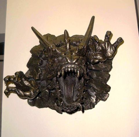 1976 Ford F-150 - A detailed sculpture of a dragon's head is mounted on a wall, sharp teeth and claws.