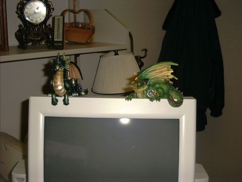 1976 Ford F-150 - Dragon figurines are placed on a computer monitor, with a clock and basket visible on a shelf in the background.