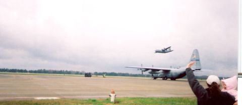 1988 Ford Bronco - Military transport planes are seen on an airfield with people observing the aircraft.