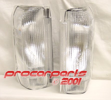 1990 Ford Bronco - pair of clear truck tail light lens assemblies photographed on a white cloth with a procarparts 2001 watermark.