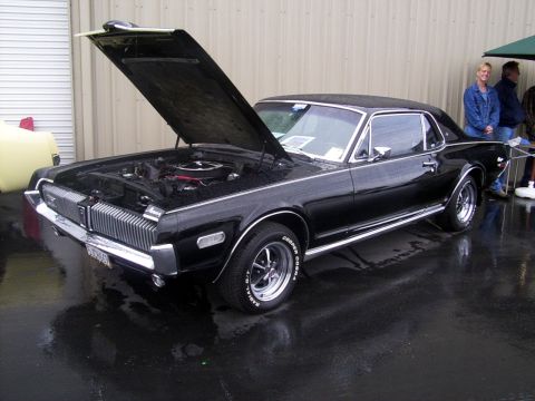 2002 Ford Mustang - A black 1969 Mercury Cougar XR7 is displayed with its hood open, revealing the engine compartment.