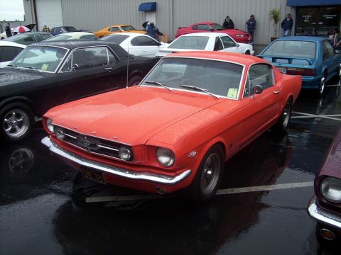 2002 Ford Mustang - Red 1965 Ford Mustang coupe with chrome bumper and grille.