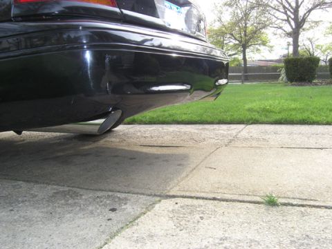 1999 Ford Crown Victoria - Rear view of a 1999 Ford Crown Victoria, showing the bumper and exhaust.