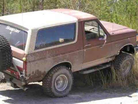 1988 Ford Bronco - This Ford Bronco appears to be from the late 1980s, possibly a 1987 model, seen here navigating rough terrain.