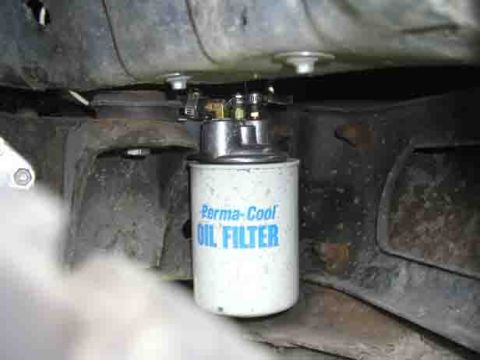 1988 Ford Bronco - Underbody shot of a white Perma-Cool spin-on oil filter mounted to a remote filter head bolted to the frame rail, with brass fittings and h…