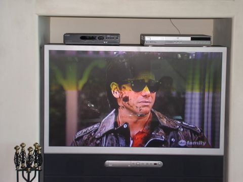 1990 Ford Bronco - A television displays a scene with a man wearing sunglasses and a leather jacket.