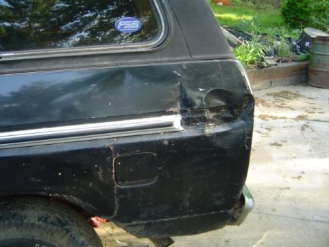1979 Ford Bronco - Damage to the rear quarter panel of a black 1979 Ford Bronco.