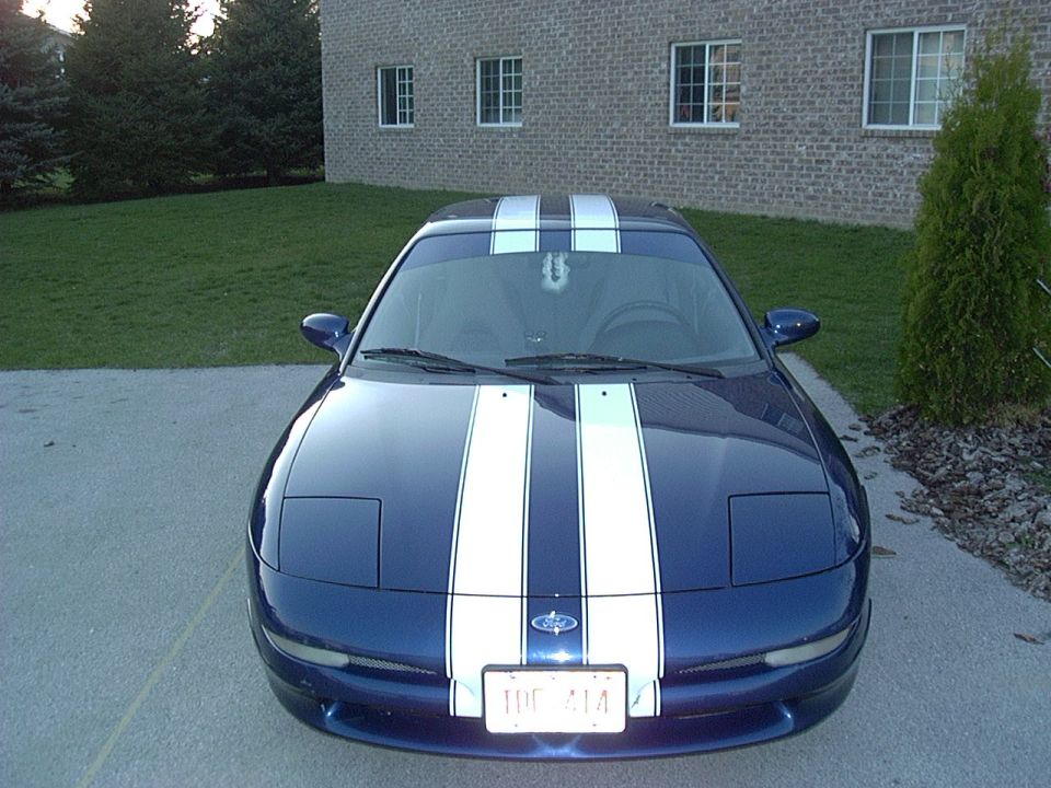 Dark blue Ford Probe coupe with white racing stripes, front view on driveway