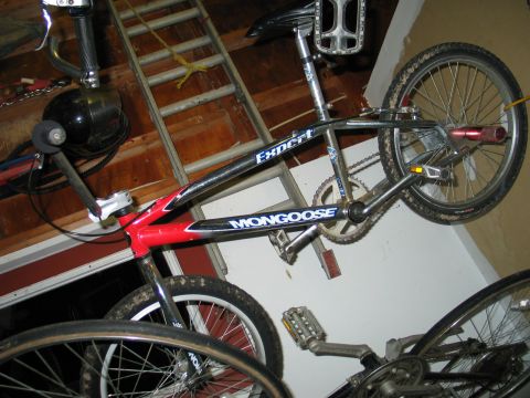 1995 Ford Bronco - A Mongoose Expert BMX bike is seen hanging in a garage, with another bicycle partially visible below.
