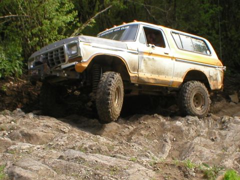 1978 Ford Bronco - A 1978 Ford Bronco navigates a rocky trail, demonstrating its off-road capabilities.