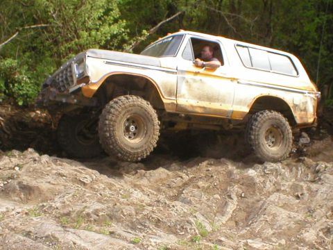 1978 Ford Bronco - A 1978 Ford Bronco navigates a challenging rocky terrain, demonstrating its off-road capabilities.