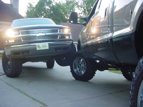 2000 Chevrolet Tahoe - A black 2000 Chevrolet Tahoe is shown from the front, parked closely beside another large truck.