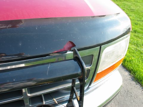 1995 Ford Bronco - Front view of a 1995 Ford Bronco showing damage to the hood and grille area.