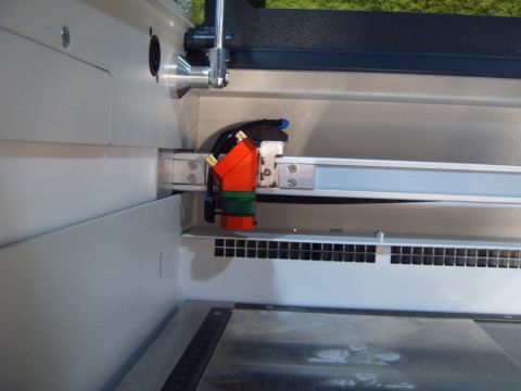 1988 Ford Bronco - Close-up of a laser cutter head assembly, showing its intricate mechanical components.