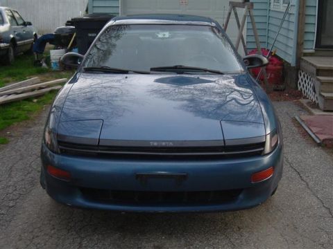 1990 Toyota Celica - The front of a blue 1990 Toyota Celica is shown parked on an asphalt driveway.