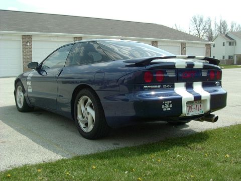 1995 Ford Probe - Rear view of a blue 1995 Ford Probe GT with white racing stripes and a spoiler.