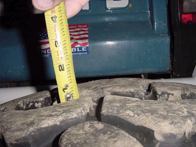 Measuring tire tread depth on a vehicle with a tape measure