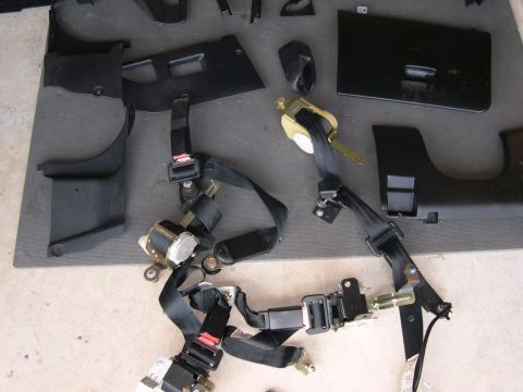 1997 Ford Probe - Interior trim pieces and seat belts are shown disassembled.