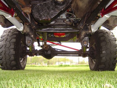 1978 Ford Bronco - Undercarriage view of a lifted 4x4 vehicle, focusing on the suspension and drivetrain.
