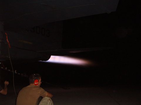 1988 Ford Bronco - The intense glow of an afterburner ignites, illuminating the dark surroundings as a person observes.