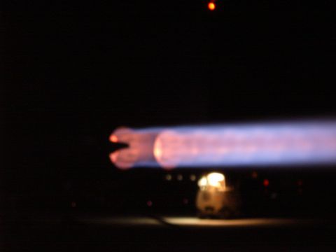 1988 Ford Bronco - Exhaust flame visible at night, with a faint object in the background.