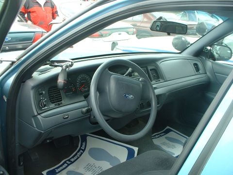 1999 Ford Crown Victoria - Interior view of a 1999 Ford Crown Victoria, highlighting the dashboard and steering wheel.