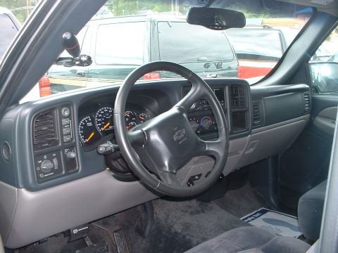 1999 Ford Crown Victoria - Interior view of a Chevrolet Silverado or GMC Sierra truck, circa 2003, with other vehicles seen outside.
