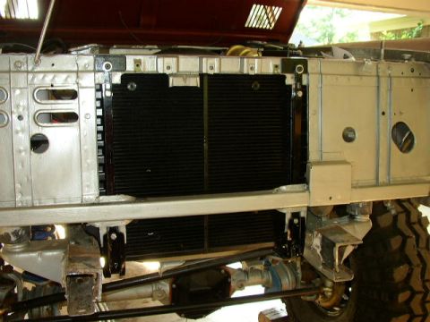 1995 Ford Bronco - Close-up view of the radiator and front suspension components of a vehicle, indicating ongoing maintenance or restoration.