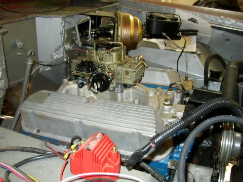 1995 Ford Bronco - Close-up of an engine bay, a carburetor and brake booster assembly.